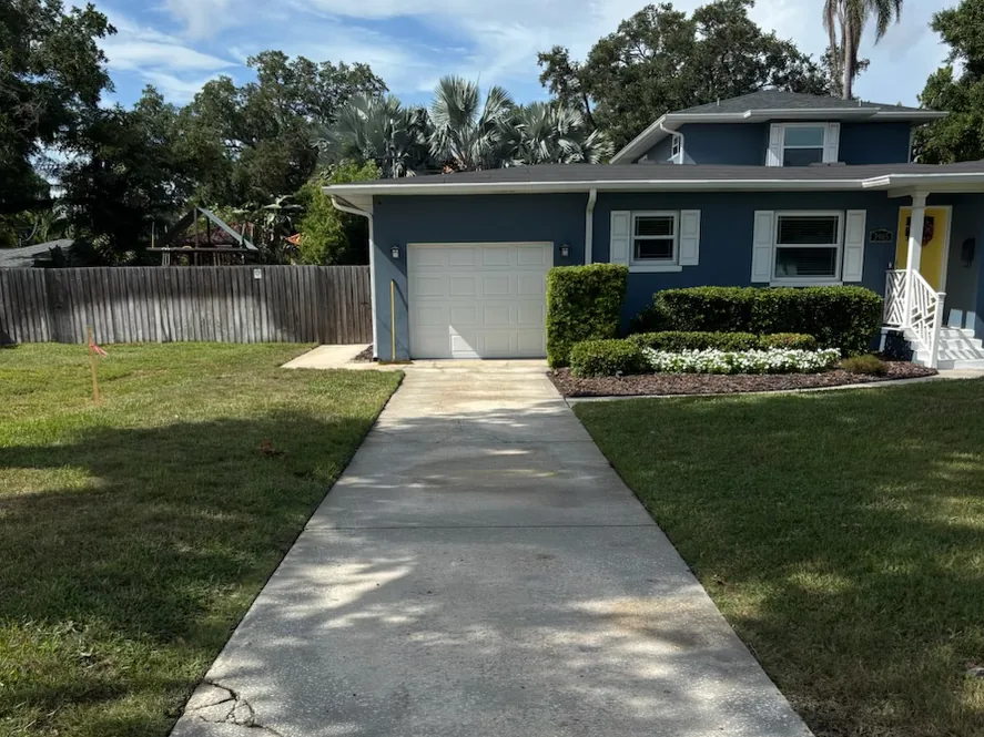 After: pressure washed driveway at a blue Tampa home