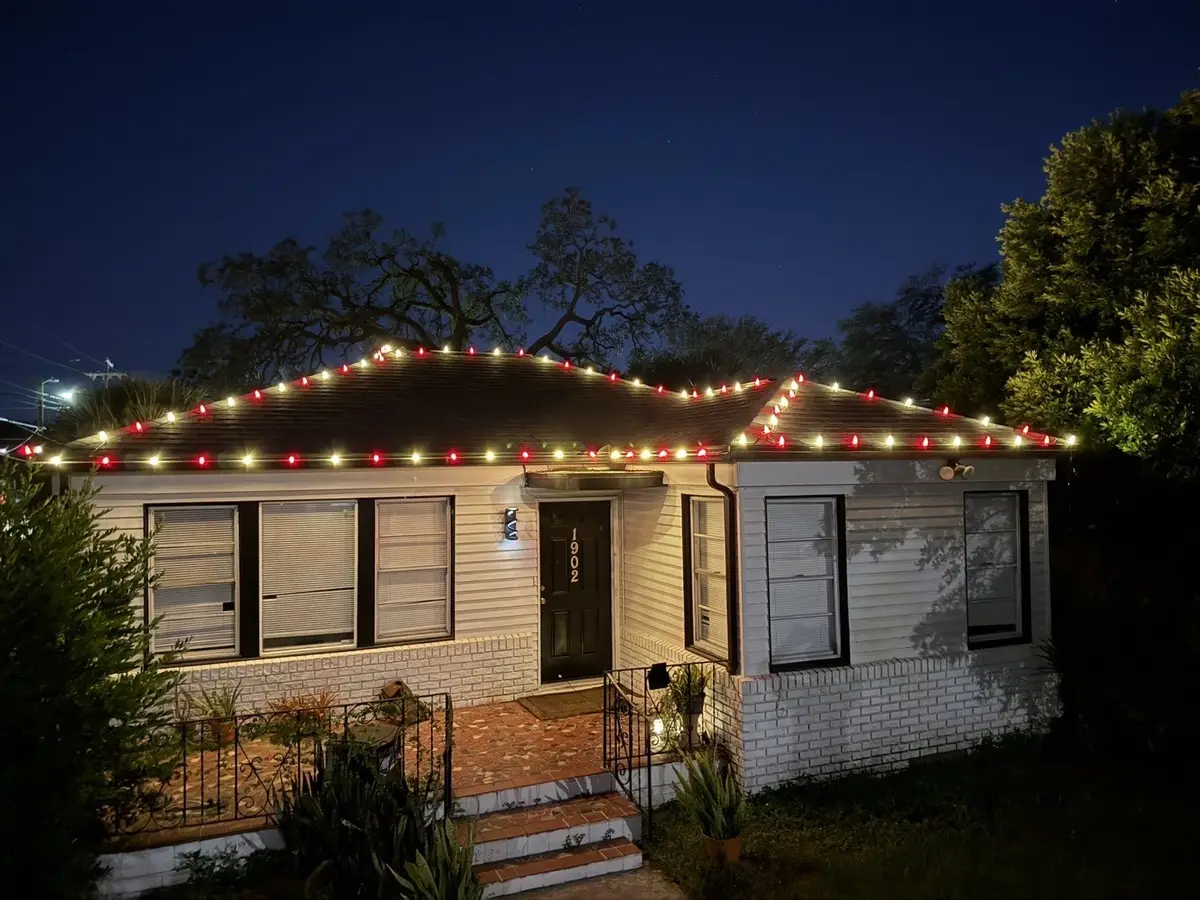 Red, green and white roofline lights on a Tampa bungalow