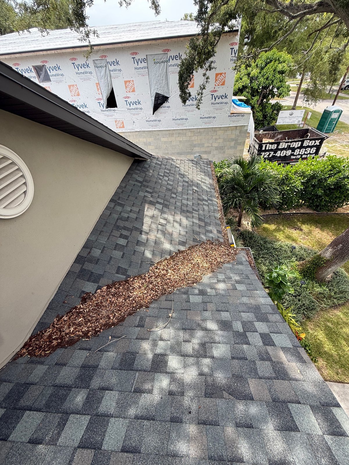 Before: roof valley packed with leaf debris in Tampa