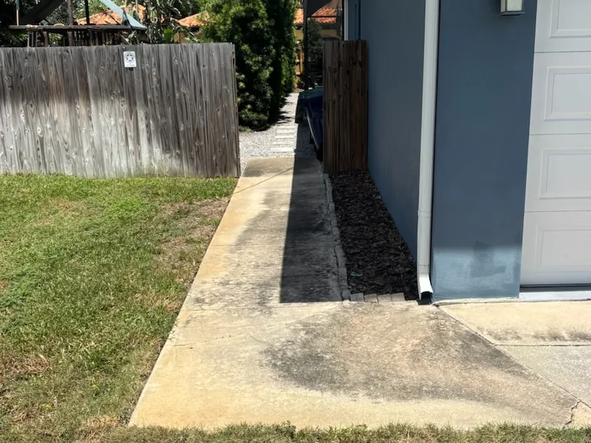Before: side walkway with rust and algae staining in Tampa